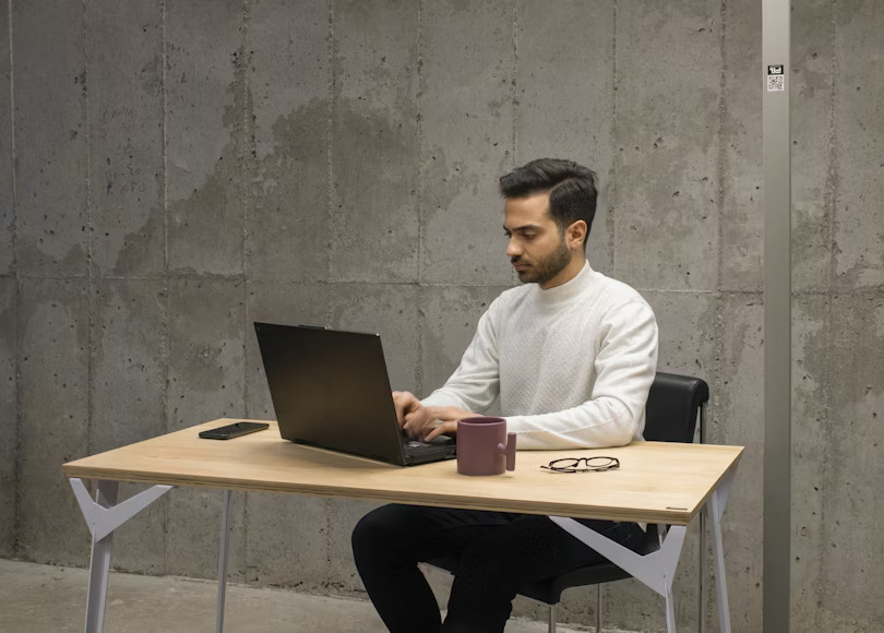 Mojahid working on a laptop
